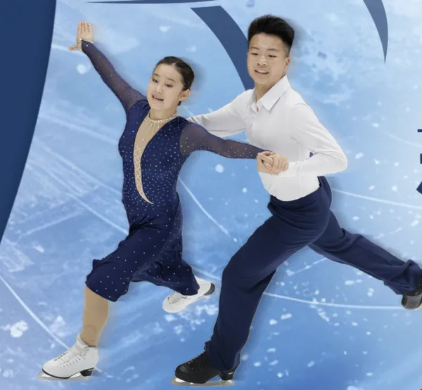 Male and female ice dance pair skating together on ice